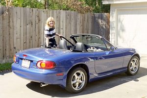Photo of Gail with new Mazda Miata convertible