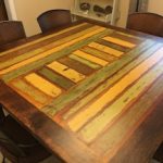 Colorful dining table made from 150-year-old wood.