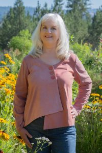 Photo of the author Gail Bergan, in a field of yellow flowers